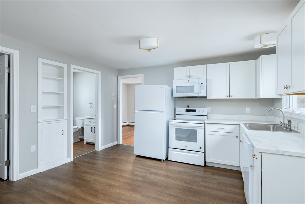 201 West Street Ware, MA 01082 - Photo 11 of 18 a kitchen with white cabinets and white appliances