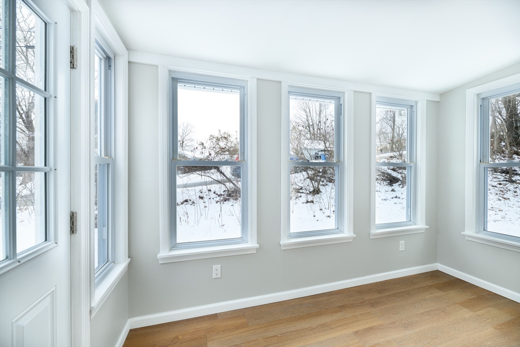 201 West Street Ware, MA 01082 - Photo 13 of 18 a view of an empty room with wooden floor and windows