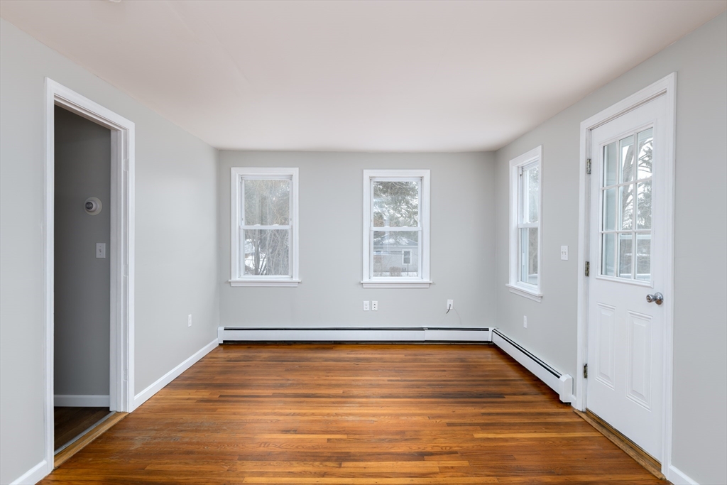 201 West Street Ware, MA 01082 - Photo 6 of 18 a view of an empty room with wooden floor and a window