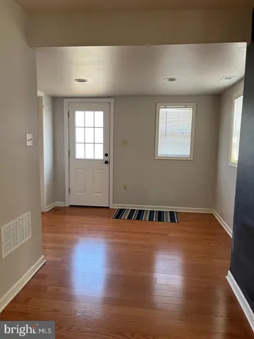 an empty room with wooden floor