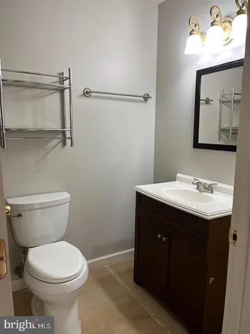 a bathroom with a sink toilet and mirror