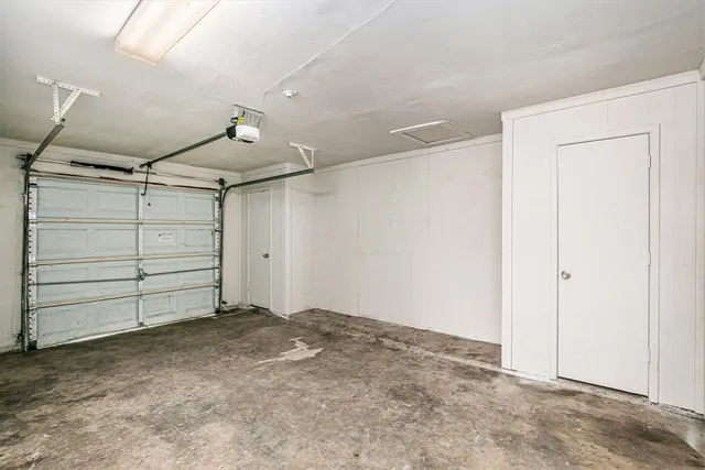 a backyard of a house with trees and wooden fence