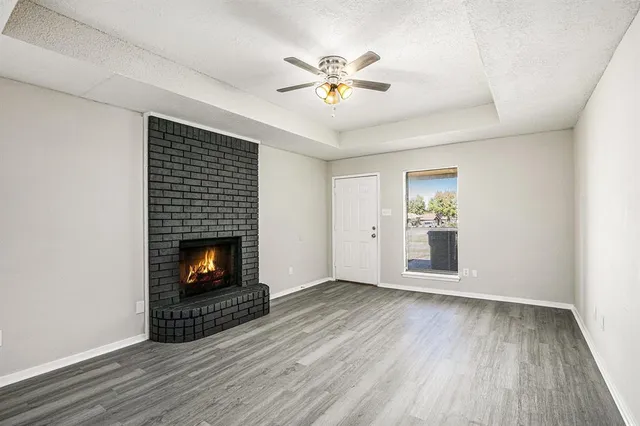 wooden floor in an empty room with a fireplace