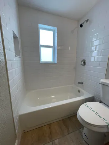a white bath tub sitting next to a white toilet