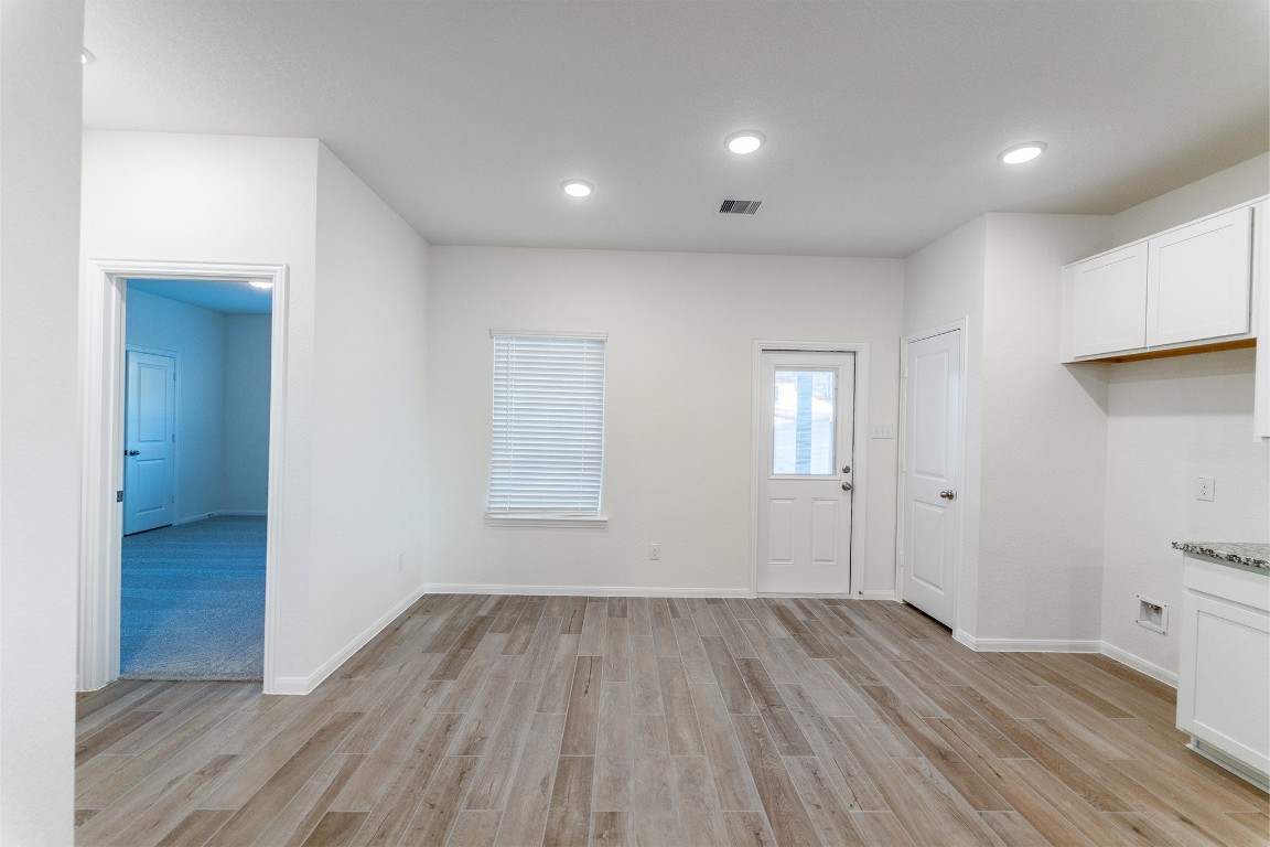 10638 Altitude Way Conroe, TX 77303 - Photo 16 of 29 wooden floor in an empty room with a window