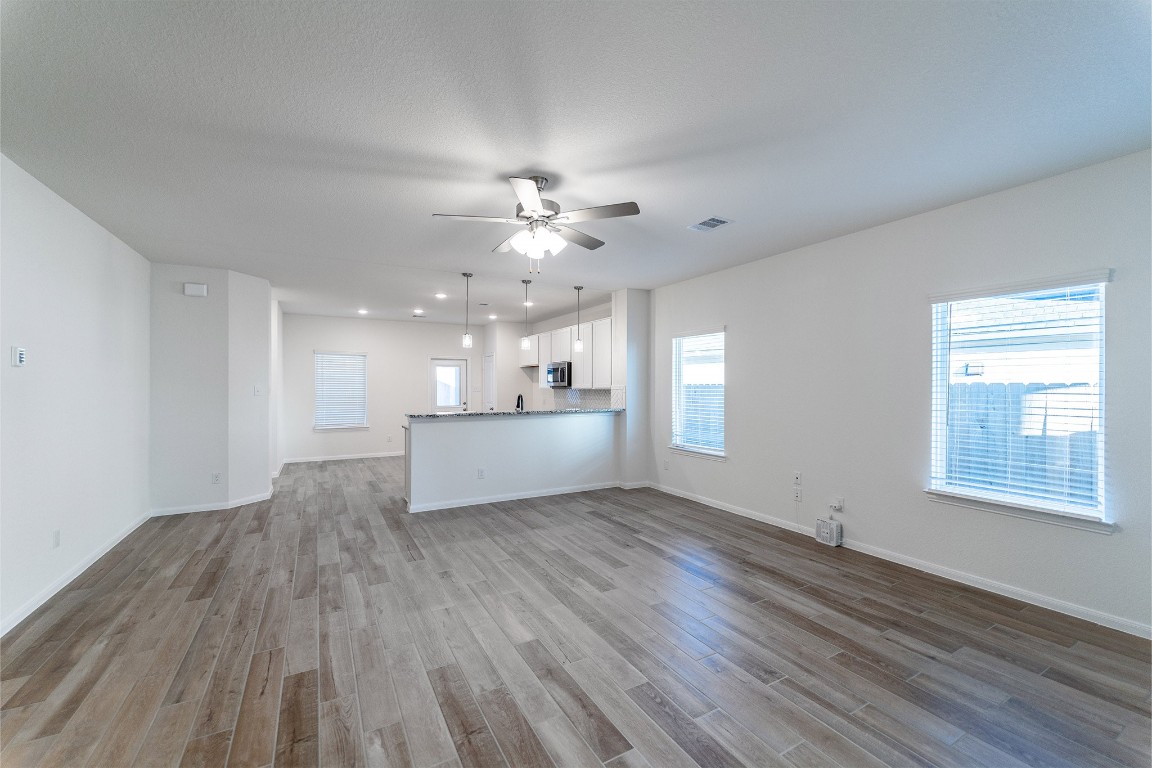 10638 Altitude Way Conroe, TX 77303 - Photo 8 of 29 a view of a kitchen with wooden floor and a kitchen sink