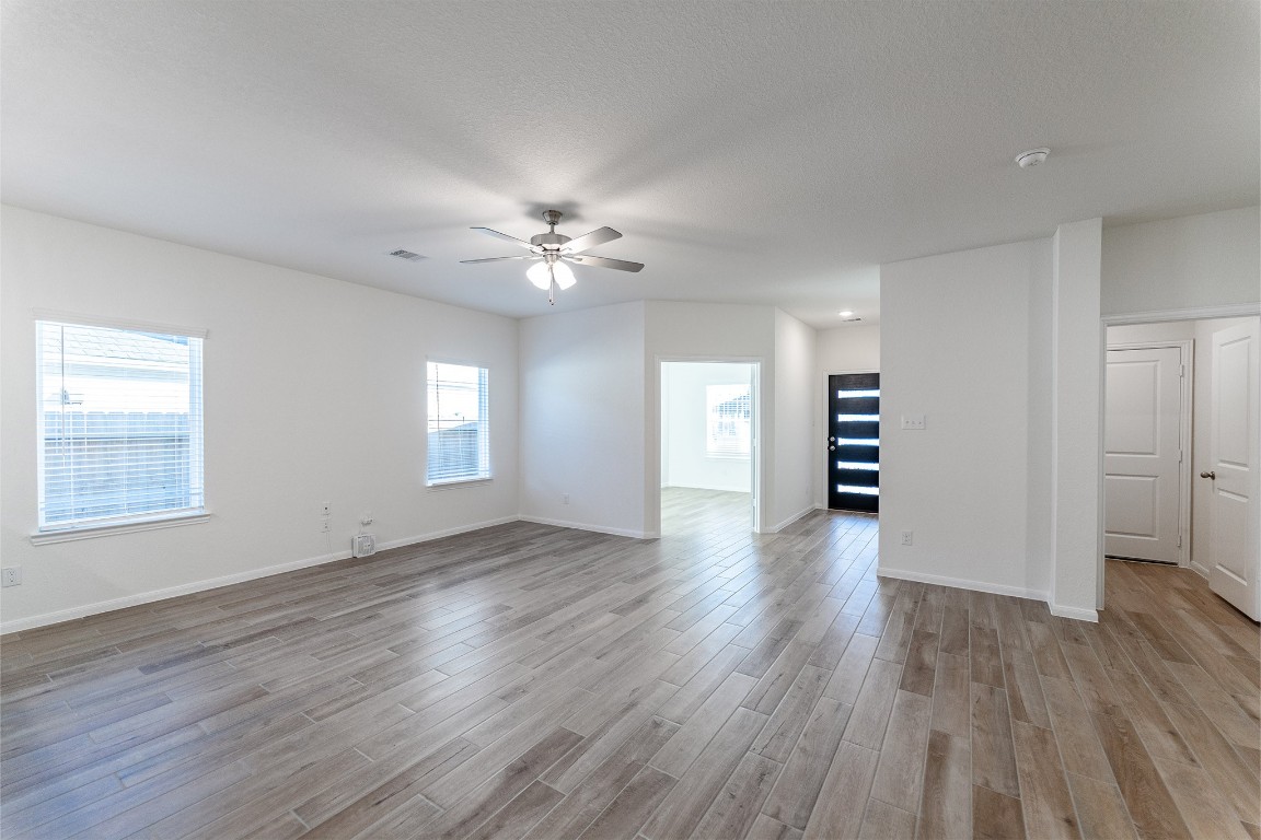 10638 Altitude Way Conroe, TX 77303 - Photo 10 of 29 a view of an empty room with a window and wooden floor