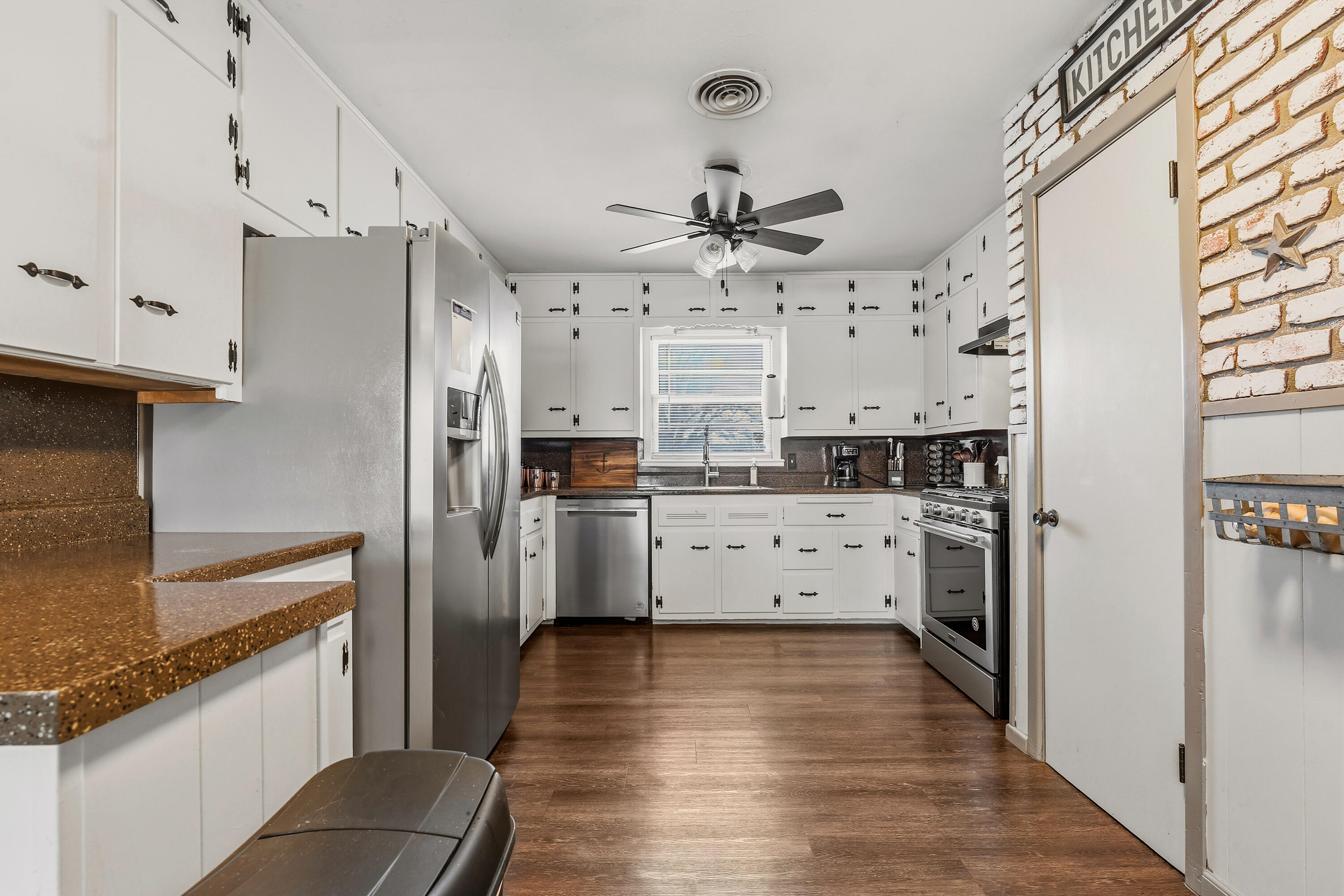 707 12th Street Shallowater, TX 79363 - Photo 11 of 27 a kitchen with stainless steel appliances a refrigerator sink and cabinets