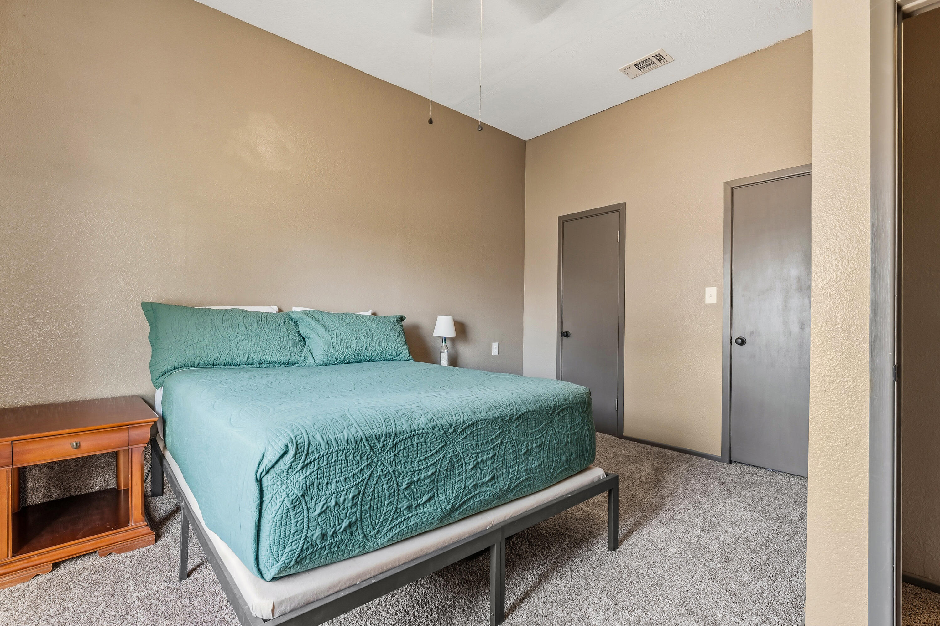 707 12th Street Shallowater, TX 79363 - Photo 16 of 27 a bedroom with a bed and a night stand