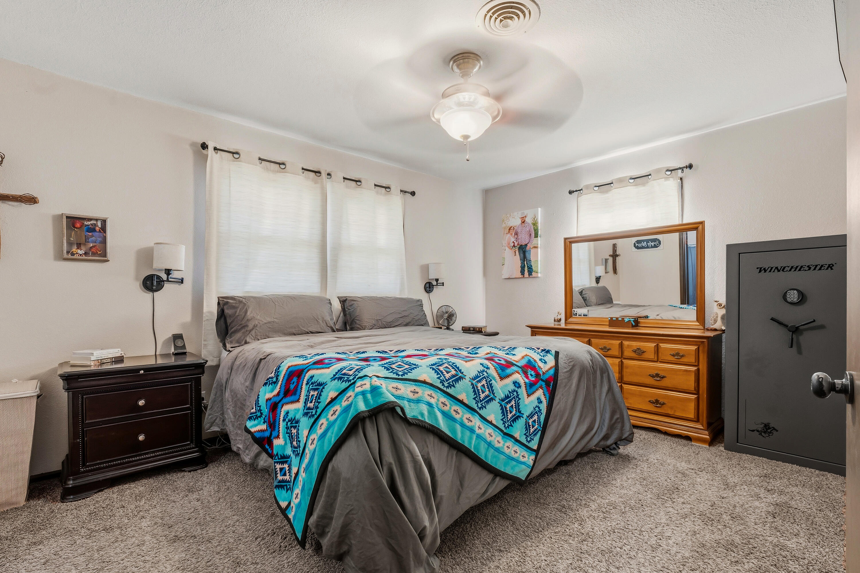 707 12th Street Shallowater, TX 79363 - Photo 17 of 27 a bedroom with a bed and a chandelier