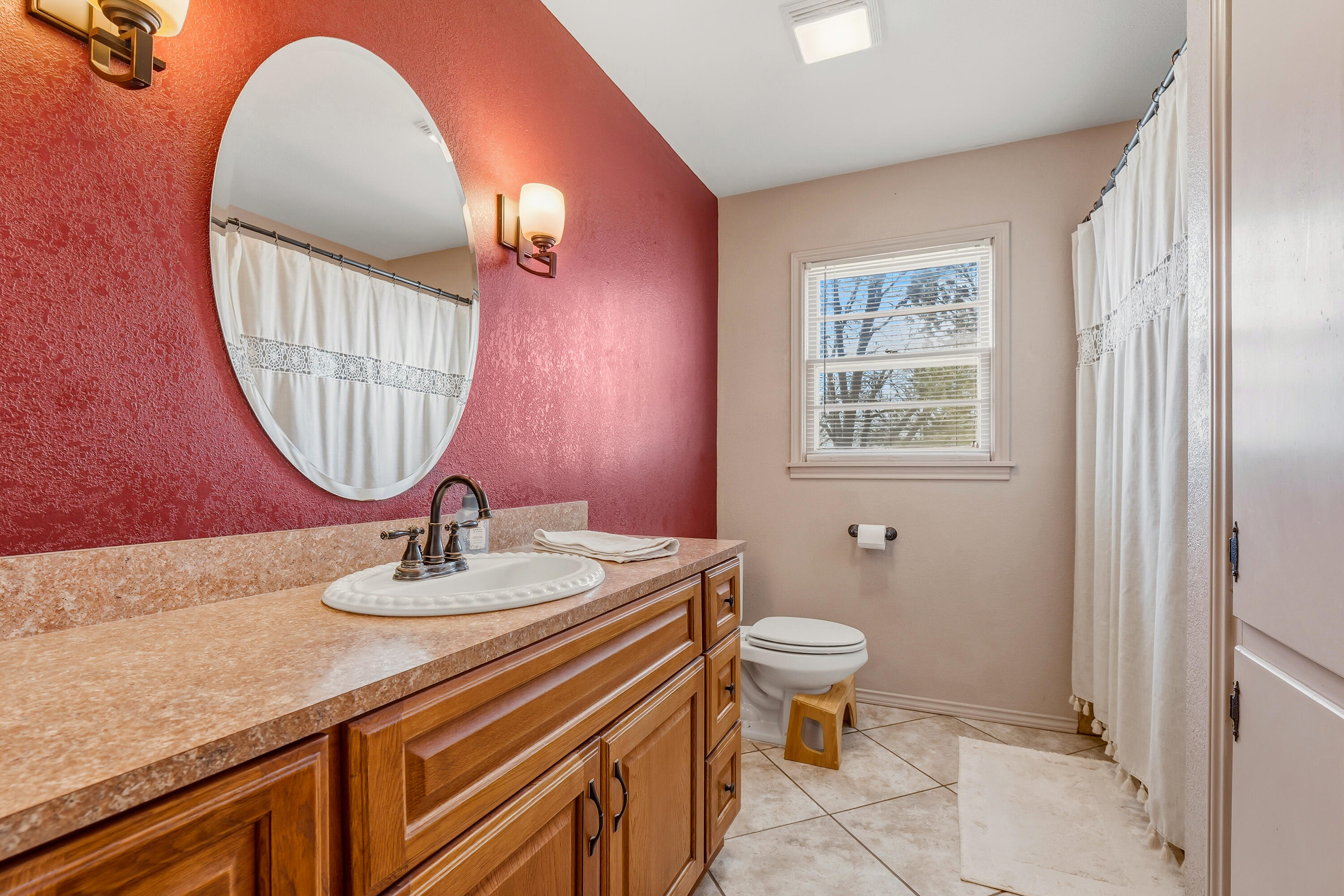 707 12th Street Shallowater, TX 79363 - Photo 19 of 27 a bathroom with a sink a toilet and a mirror