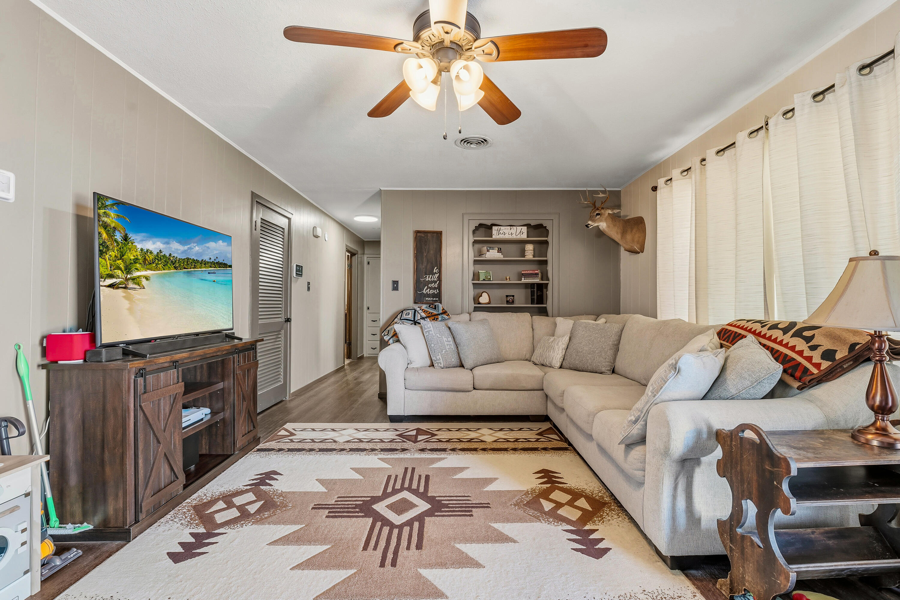 707 12th Street Shallowater, TX 79363 - Photo 5 of 27 a living room with furniture and a flat screen tv