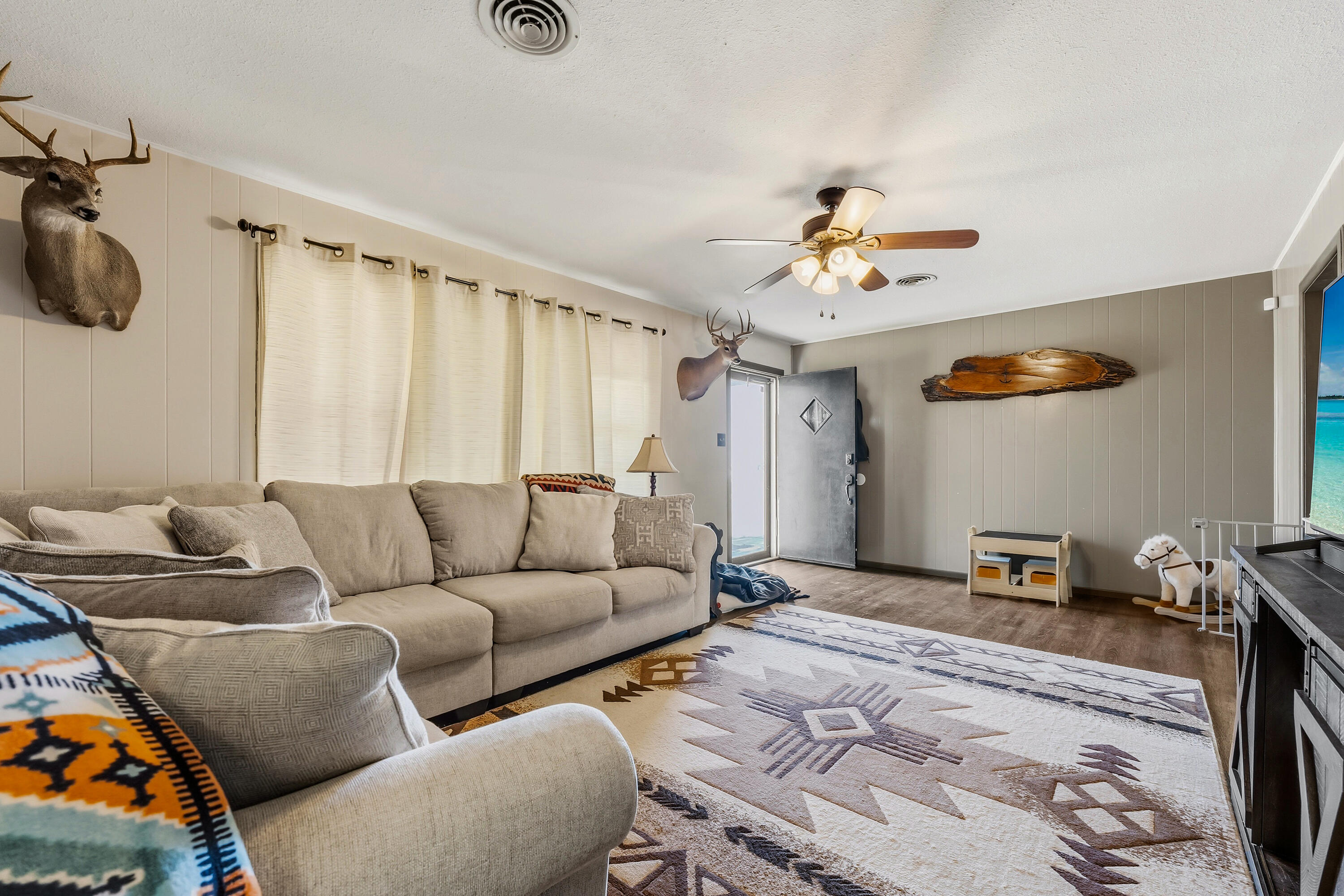 707 12th Street Shallowater, TX 79363 - Photo 7 of 27 a living room with furniture and a chandelier