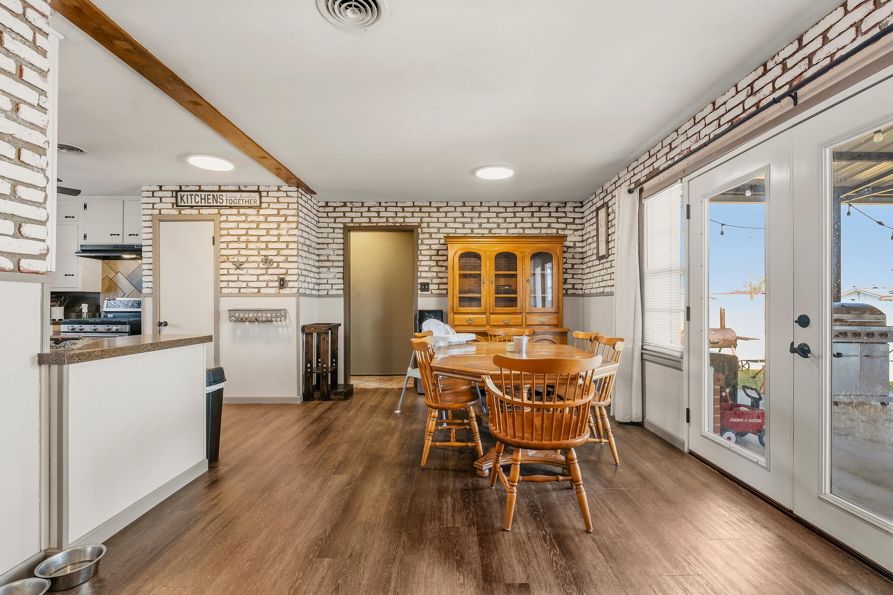 707 12th Street Shallowater, TX 79363 - Photo 9 of 27 a dining room with furniture and wooden floor