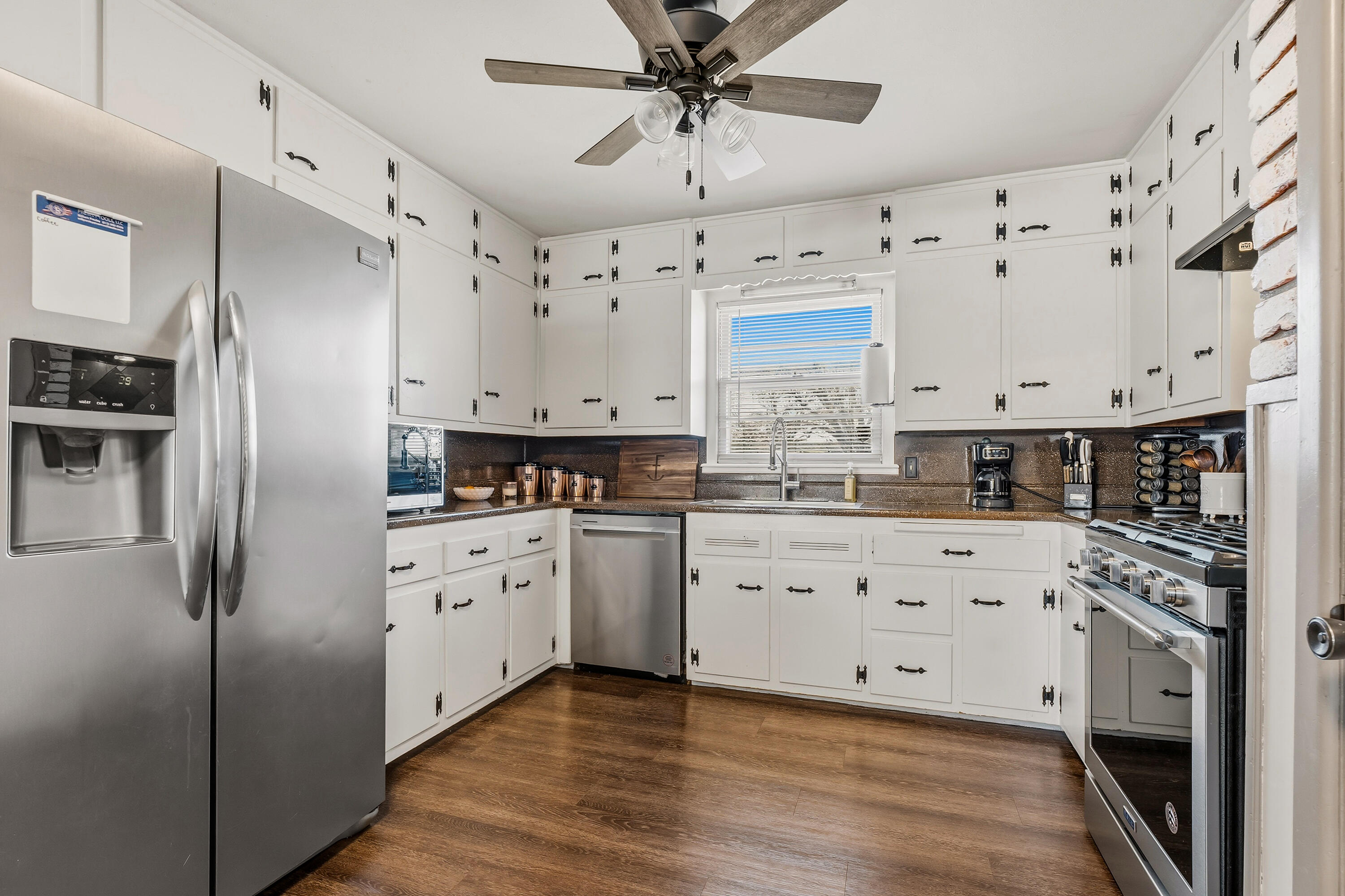 707 12th Street Shallowater, TX 79363 - Photo 10 of 27 a kitchen with stainless steel appliances a refrigerator sink and cabinets