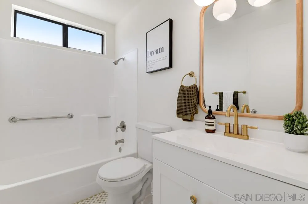 4635 Briar Ridge Road Oceanside, CA 92056 - Photo 15 of 23 a bathroom with a sink toilet and a mirror