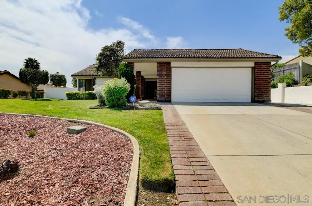 4635 Briar Ridge Road Oceanside, CA 92056 - Photo 18 of 23 a front view of a house with a yard and garage