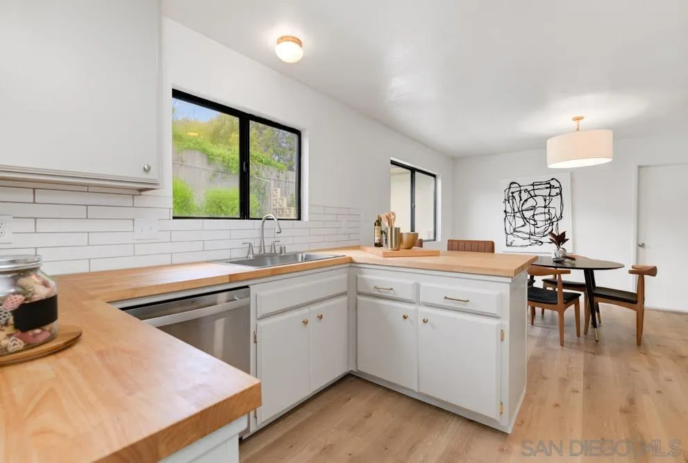 4635 Briar Ridge Road Oceanside, CA 92056 - Photo 2 of 23 a kitchen with sink cabinets and dining table