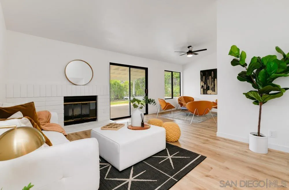 4635 Briar Ridge Road Oceanside, CA 92056 - Photo 5 of 23 a living room with furniture a potted plant and a fireplace