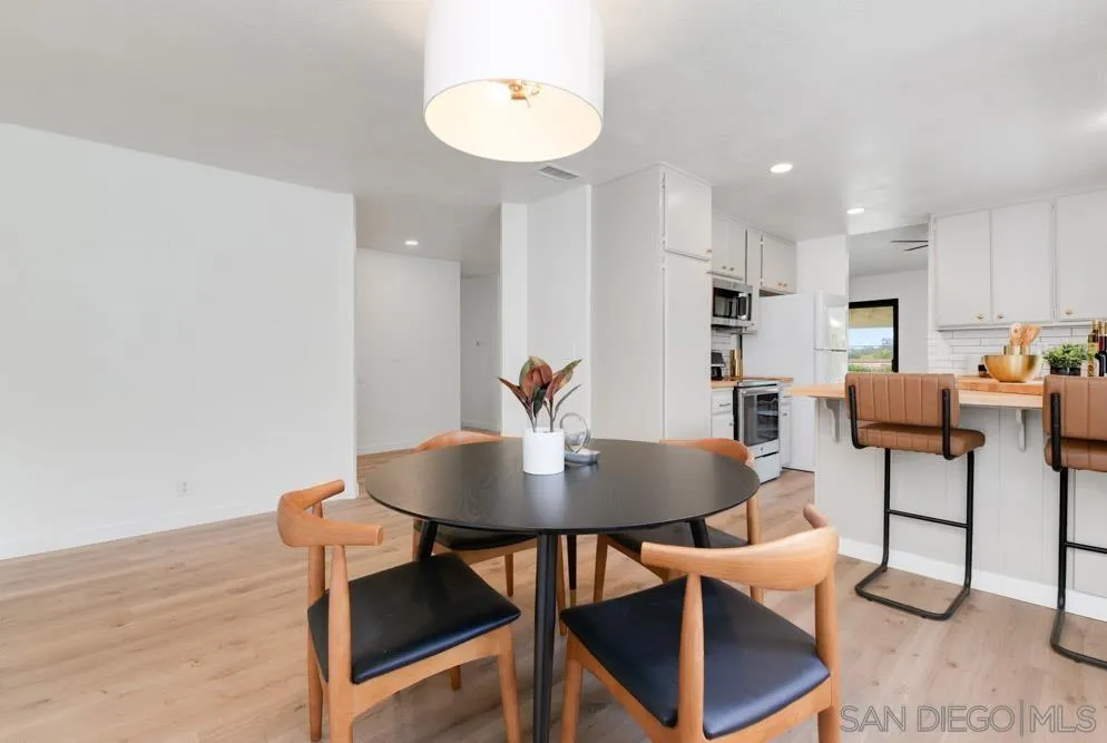 4635 Briar Ridge Road Oceanside, CA 92056 - Photo 7 of 23 a view of a dining room with furniture and wooden floor