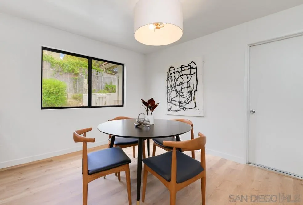 4635 Briar Ridge Road Oceanside, CA 92056 - Photo 10 of 23 a view of a dining room with furniture window and wooden floor