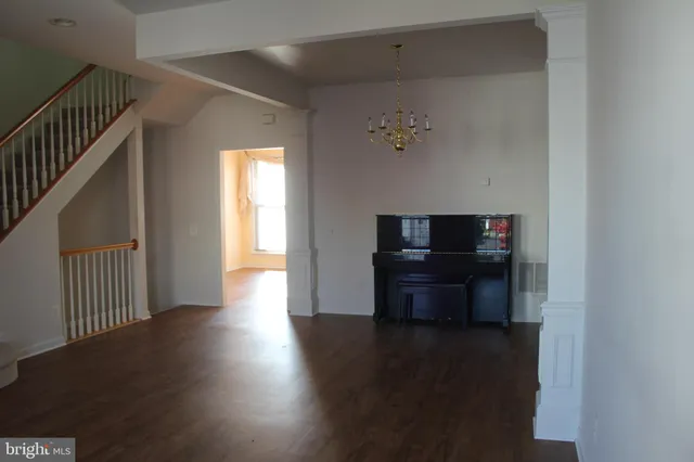 a living room with hard wood floors and a wooden floor