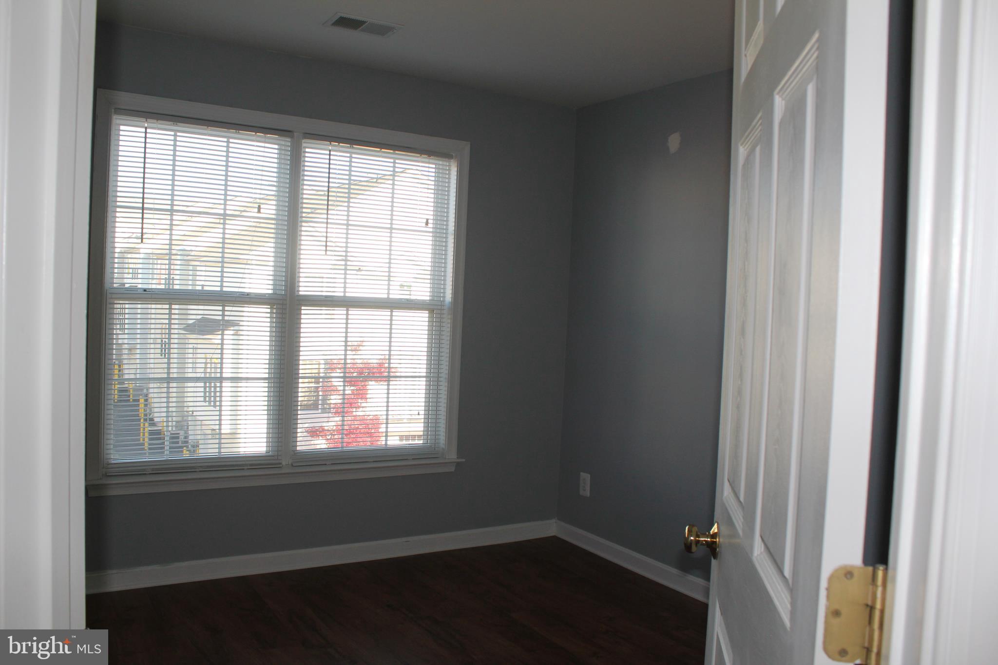 13507 Stargazer Terrace Centreville, VA 20120 - Photo 15 of 25 an empty room with wooden floor and windows