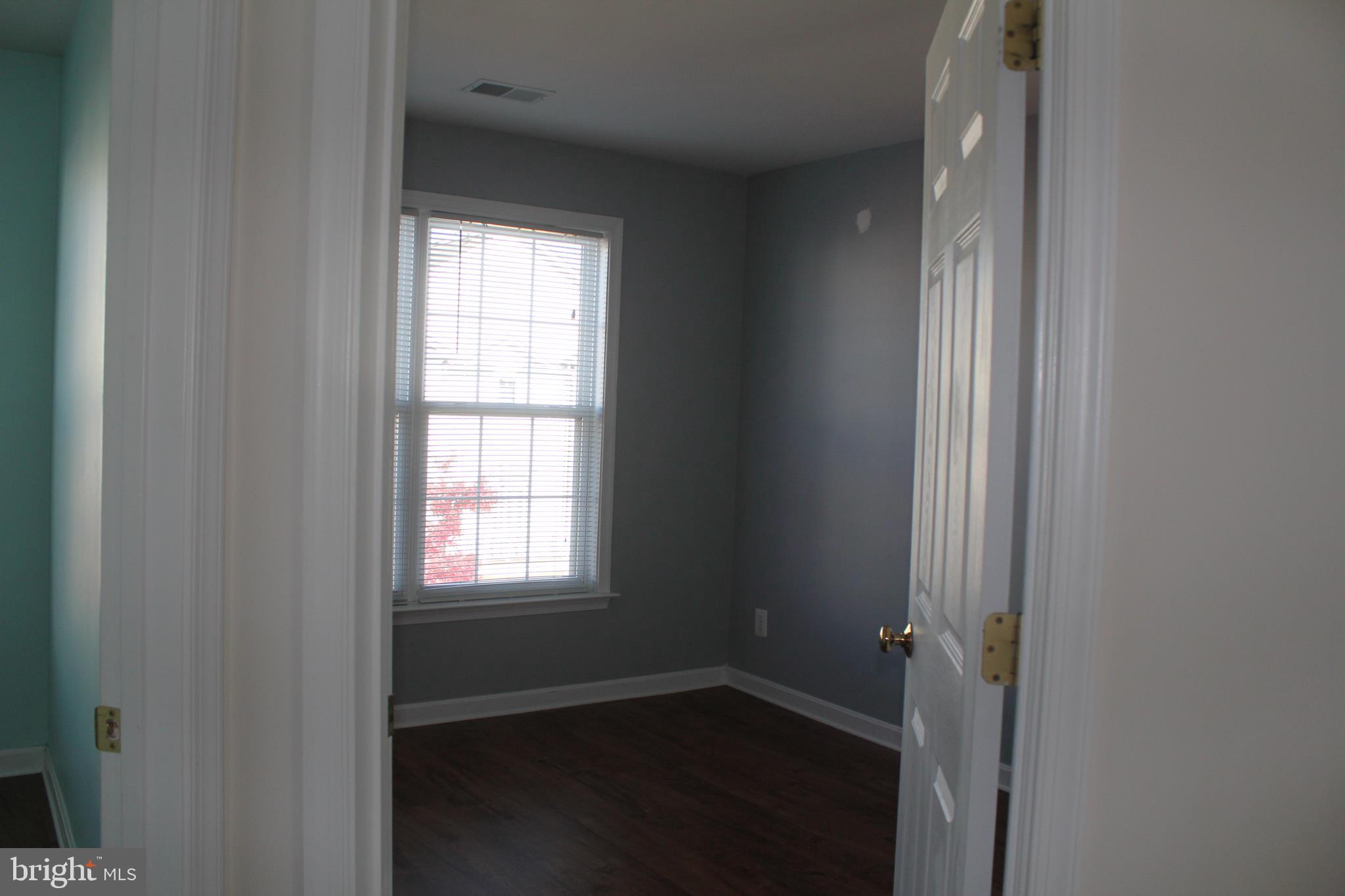 13507 Stargazer Terrace Centreville, VA 20120 - Photo 17 of 25 a view of an empty room with wooden floor and a window