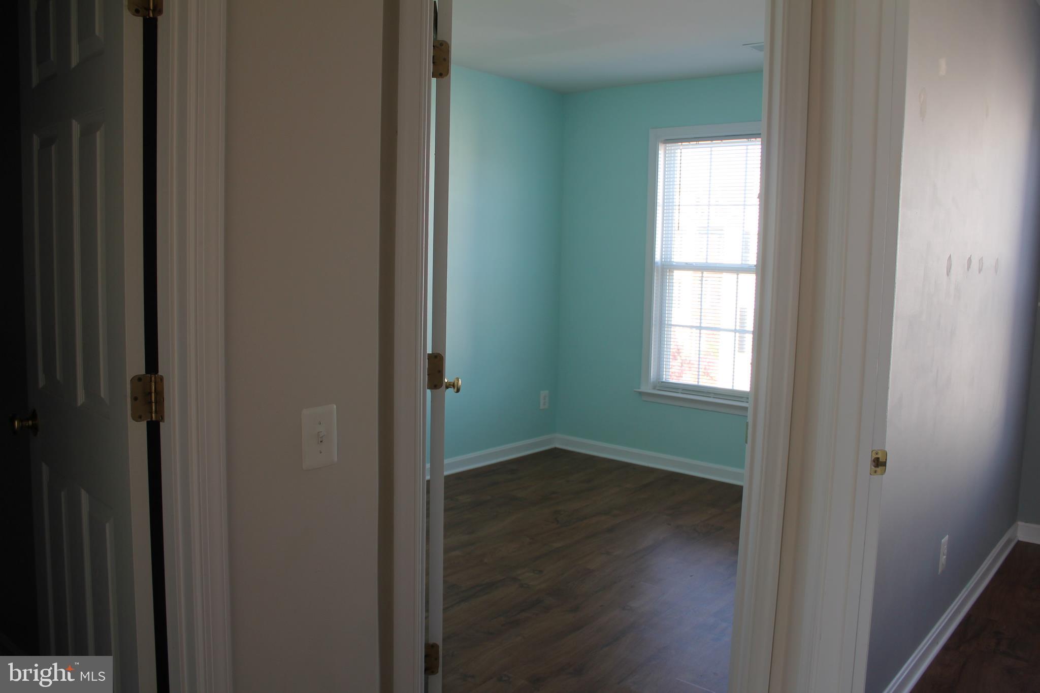 13507 Stargazer Terrace Centreville, VA 20120 - Photo 19 of 25 a view of an empty room with wooden floor and a window