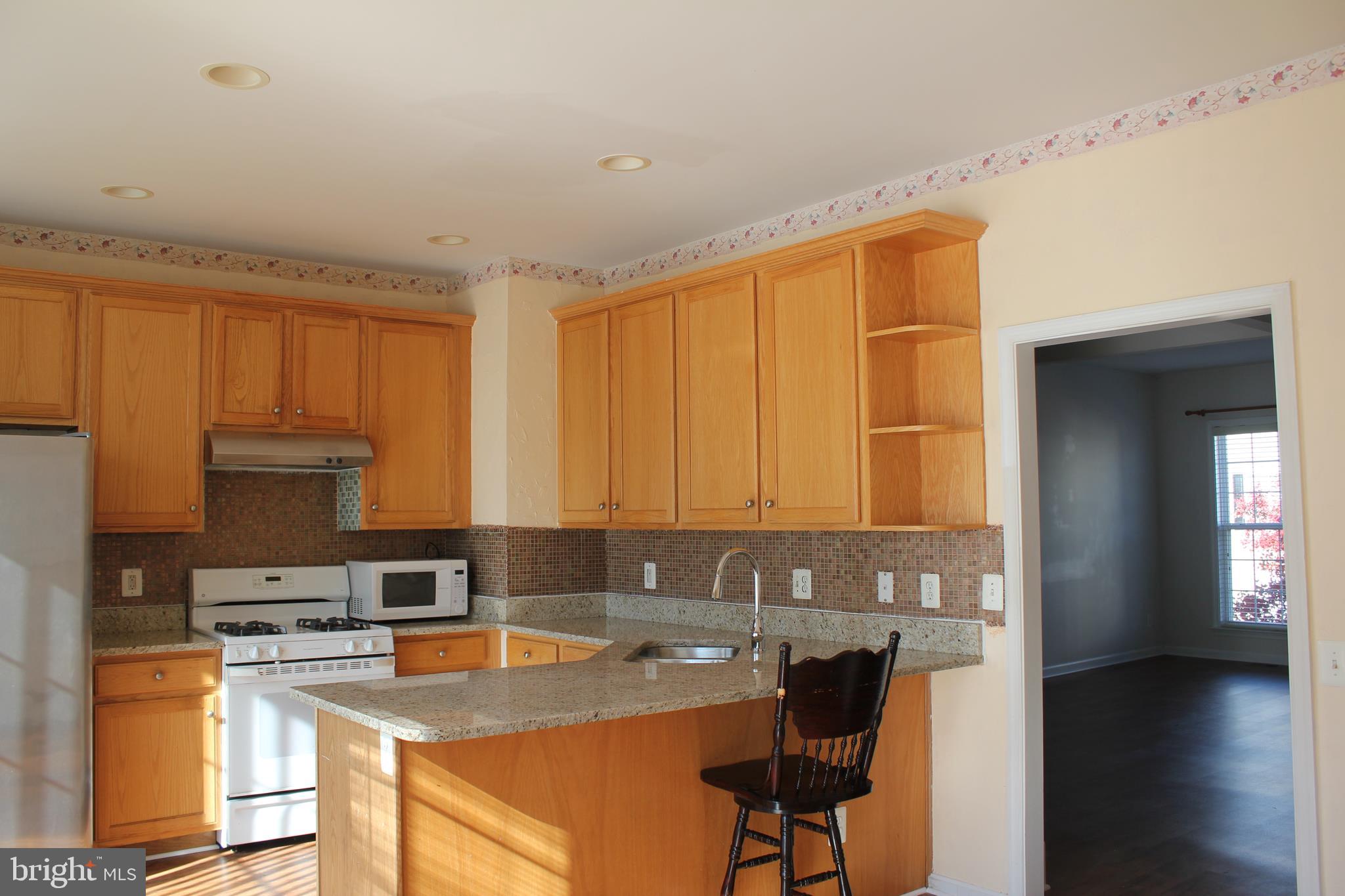 13507 Stargazer Terrace Centreville, VA 20120 - Photo 6 of 25 a kitchen with a sink a counter top space cabinets and appliances