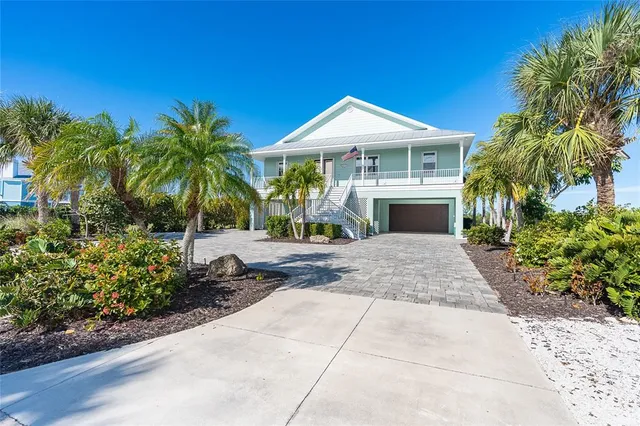 a front view of a house with garden and entryway