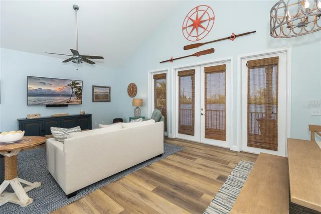 a living room with furniture a chandelier and a window