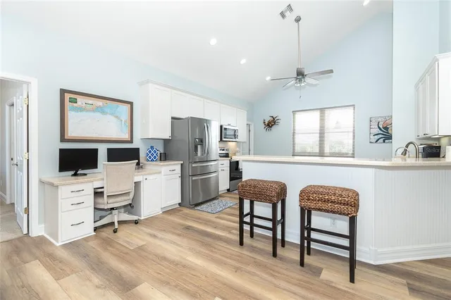 a view of living room kitchen with furniture and wooden floor