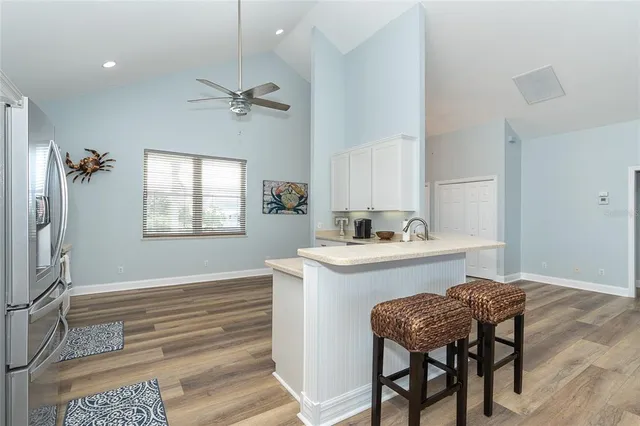 a kitchen with a refrigerator stove and cabinets