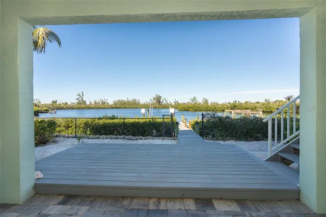 a view of a roof deck with couches and sky view