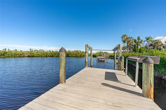 a front view of a house with a yard and potted plants