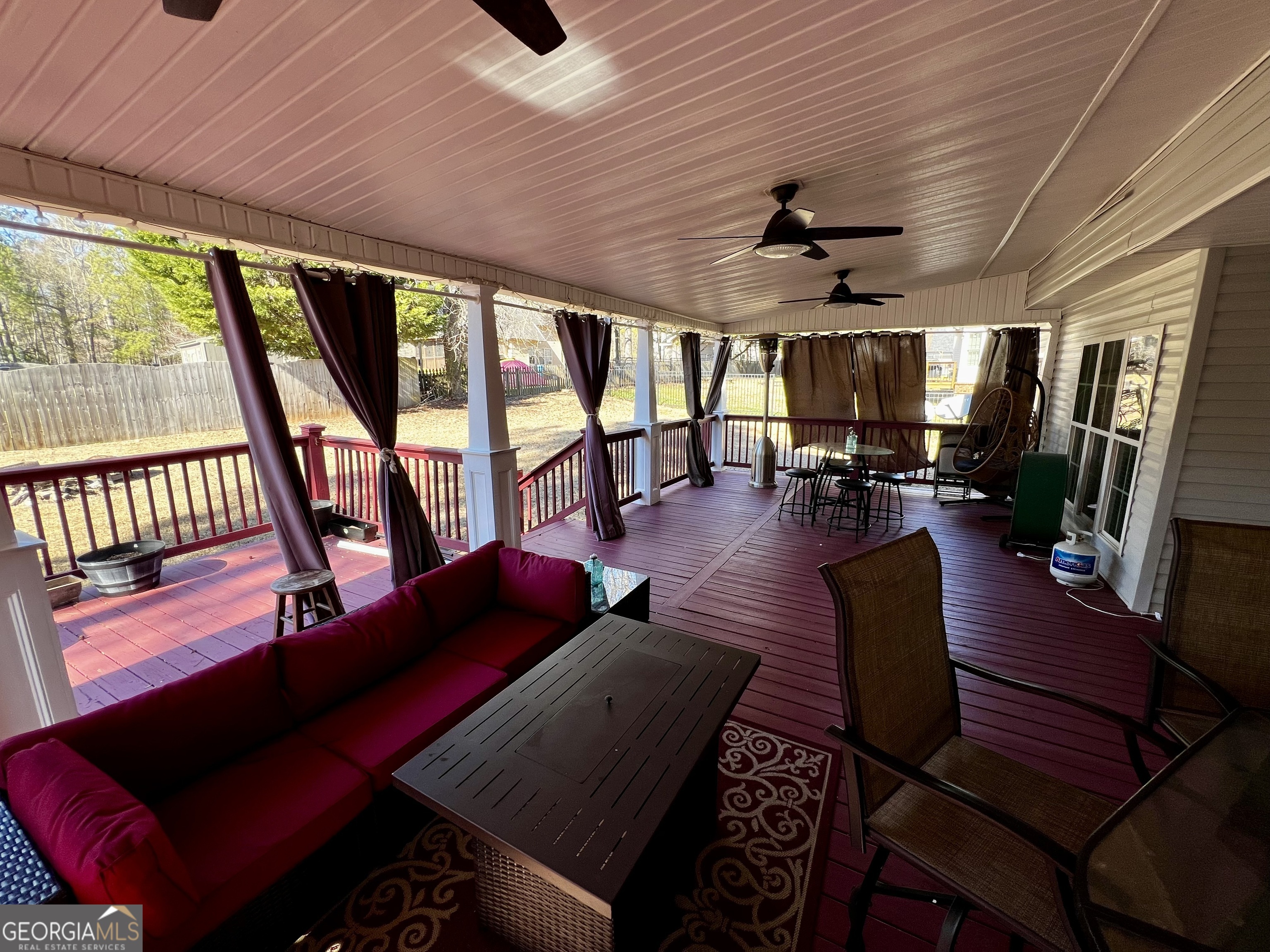 1104 Boulder Drive Gray, GA 31032 - Photo 65 of 81 a living room with furniture a ceiling fan and a large window