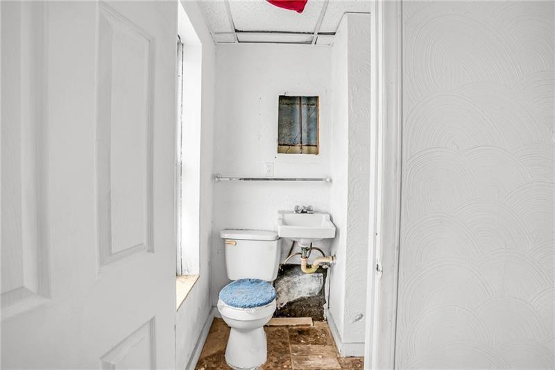 214 Brownsville Road Pittsburgh, PA 15210 - Photo 20 of 29 a bathroom with a toilet and a sink