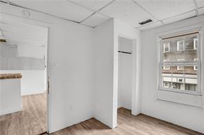 214 Brownsville Road Pittsburgh, PA 15210 - Photo 22 of 29 a view of an empty room with wooden floor and a window