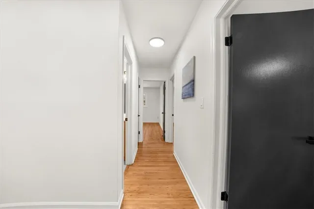 a view of empty room with wooden floor