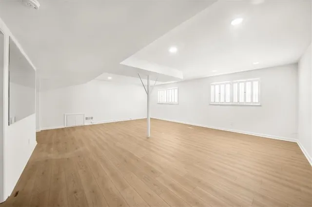 a view of a house with a wooden fence