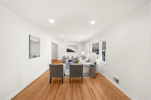 a dining room with furniture and wooden floor