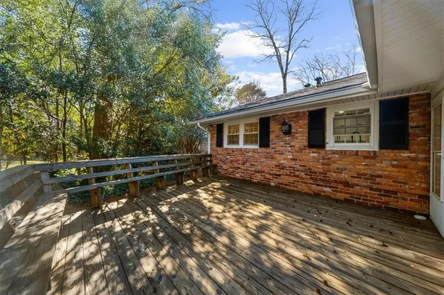 a view of a swimming pool in a yard with palm trees