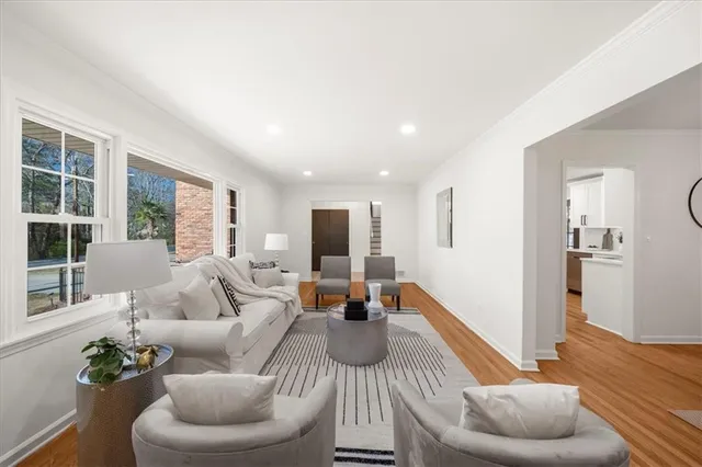 a dining room with furniture a chandelier and wooden floor