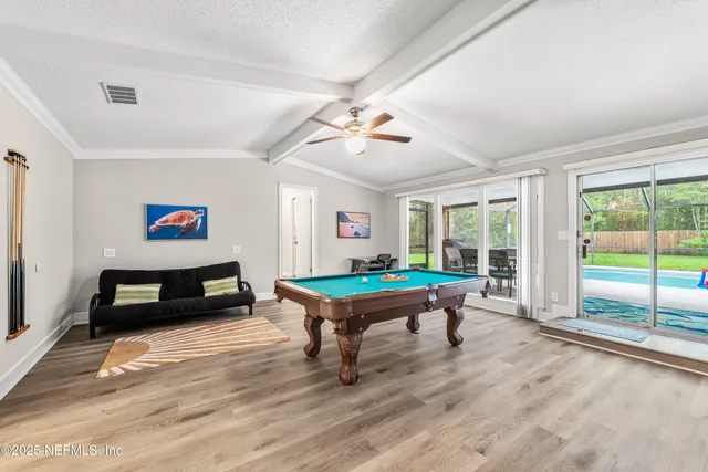 a living room with furniture a table and a large window