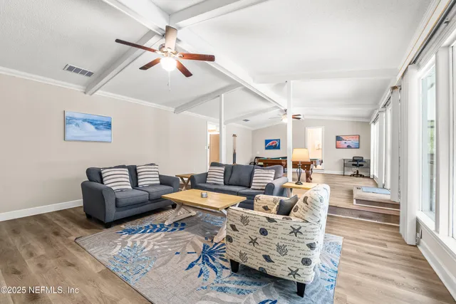 a living room with furniture or couch and a wooden floor