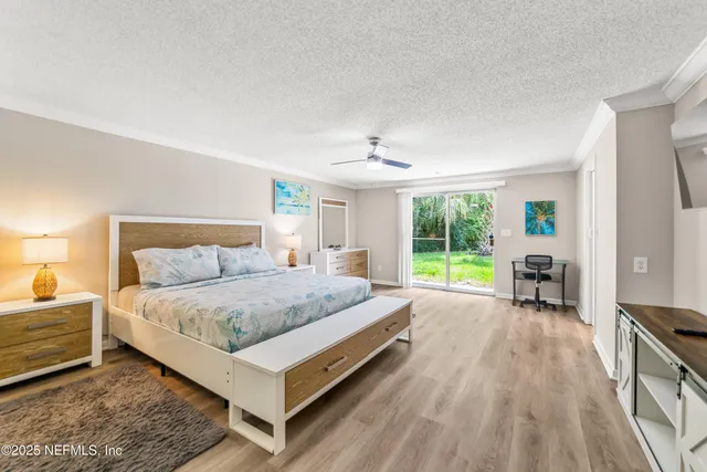 a spacious bedroom with a bed and large windows