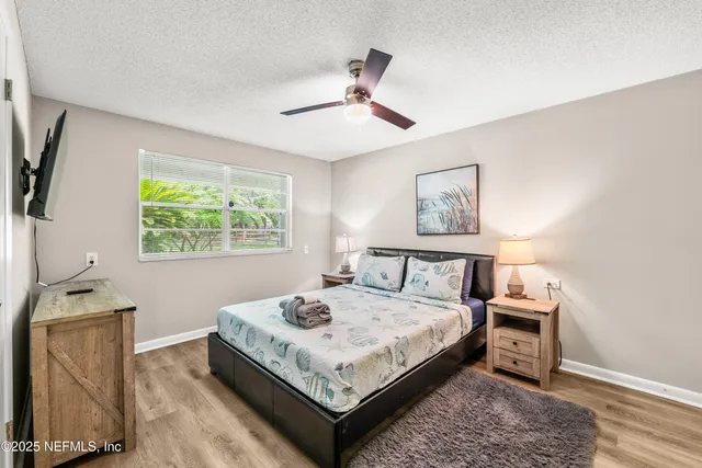a bed sitting in a bedroom next to a window