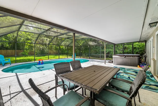 a view of a patio with a table and chairs