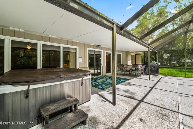 a view of a house with a backyard patio and swimming pool